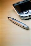 Close-up of a fountain pen with a personal data assistant