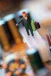 Close-up of the figurine of a businessman with a briefcase on a circuit board