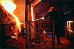 Rear view of a manual worker working in a steel mill