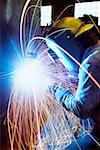 Welder welding a large tank, Chicago, Illinois, USA