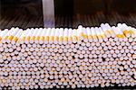 Close-up of cigarettes on an assembly line at a factory, Phillip Morris Factory, Richmond, Virginia, USA