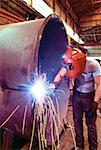 Welder welding a large tank