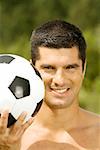 Portrait of a mid adult man holding a soccer ball