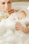 Close-up of a young woman pouring champagne in a champagne flute