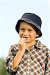 Close-up of a boy eating a chocolate