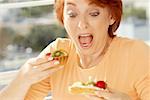 Close-up of a senior woman looking at a fruit tart