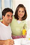 Portrait of a girl and her father holding a glass of juice