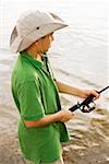 High angle view of a teenage boy fishing in a lake