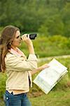 Side profile of a girl looking through a pair of binoculars