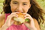 Portrait of a girl eating a burger