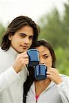 Close-up of a young couple drinking coffee