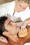 High angle view of a massage therapist talking to a young man