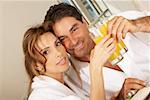 Portrait of a mid adult couple toasting with glasses of juice