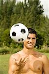 Portrait of a mid adult man tossing a soccer ball
