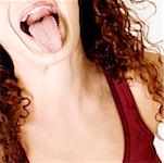 Close-up of a young woman sticking out her tongue