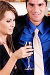 Side profile of a mid adult woman holding a glass of champagne with a mid adult man beside her