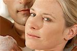 Portrait of a young woman with a young man in a bubble bath