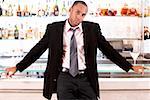 Portrait of a businessman leaning against a bar counter