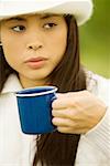 Close-up of a young woman holding a coffee cup