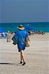 Rear view of a man walking on the beach, South Beach, Miami, Florida, USA