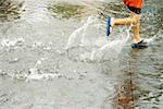 Low section view of a boy splashing water