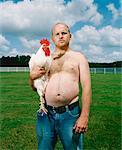 Portrait of Man Holding Rooster
