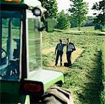 Farmer and Businessman Looking at Land
