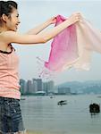 Woman Holding Scarf on the Beach