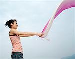 Woman Holding Scarf Outdoors