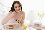 Young Woman Eating Breakfast