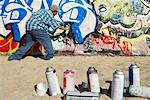 Man Spraying Graffiti on Wall