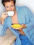 Man in Pyjamas with Coffee