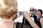 Woman Taking Couple's Portrait at Wedding