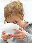 Woman Drinking From Bowl