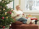 Woman in Chair by Christmas Tree