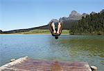 Man Jumping into Water from Dock