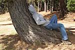 Man Lying on Tree