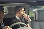 Businessman in Car With Chauffeur