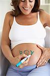 Pregnant Woman Spelling Boy on Stomach