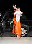 Woman with Baby in Front of Limousine