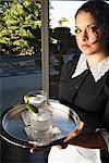 A Maid Holding Tray With Drinks