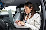 Woman in Truck Using Laptop