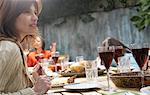 Woman At Family Dinner Outdoors