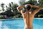 Man Standing Over Swimming Pool