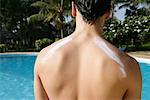 Sunscreen Lotion on Man's Back
