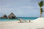 Boardwalk guiding to two bungalows in the ocean