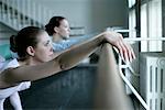 Female ballet dancers exercising at a ballet bare