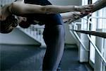 Female ballet dancers exercising at the ballet bare