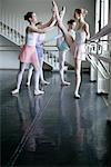 Female ballet dancers exercising at a ballet bare