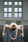 A female ballet dancer doing stretching exercises